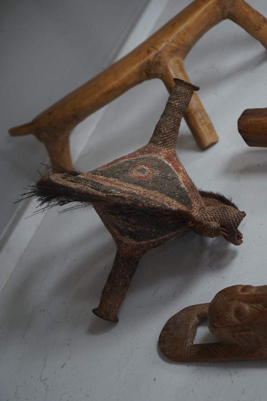 A Papua New Guinea ceremonial bone dagger, a painted straw mask, a tribal instrument and a carved stool. Condition - fair/good